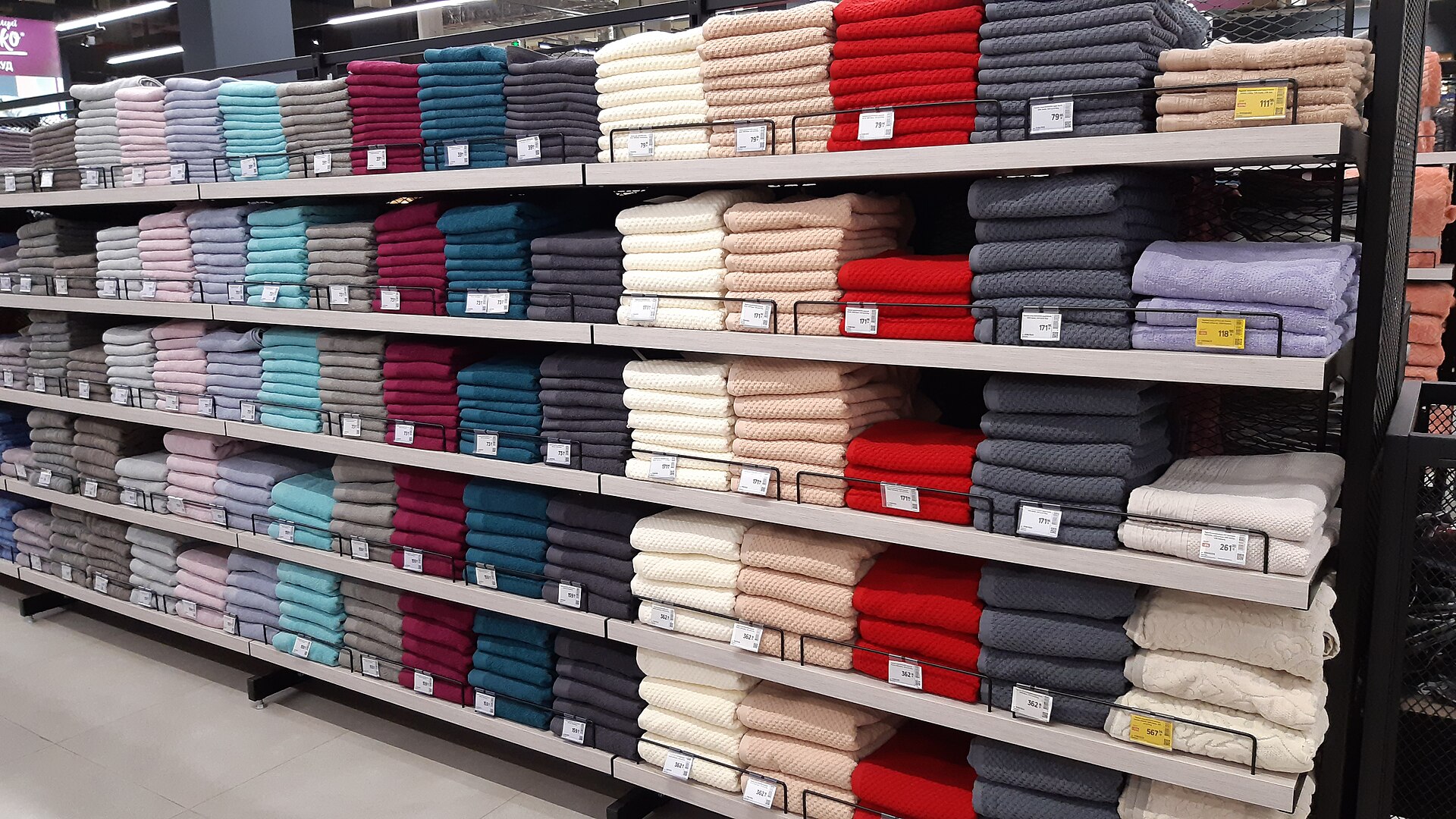 Fresh towels arranged on shelves for linen care